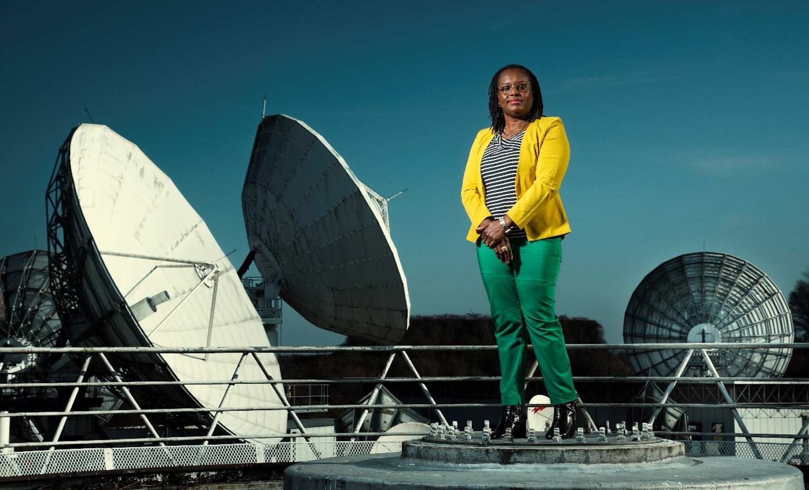  Vodafone’s Senior Manager of Satellite Engineering Cynthia Osuigwe standing next to the satellites